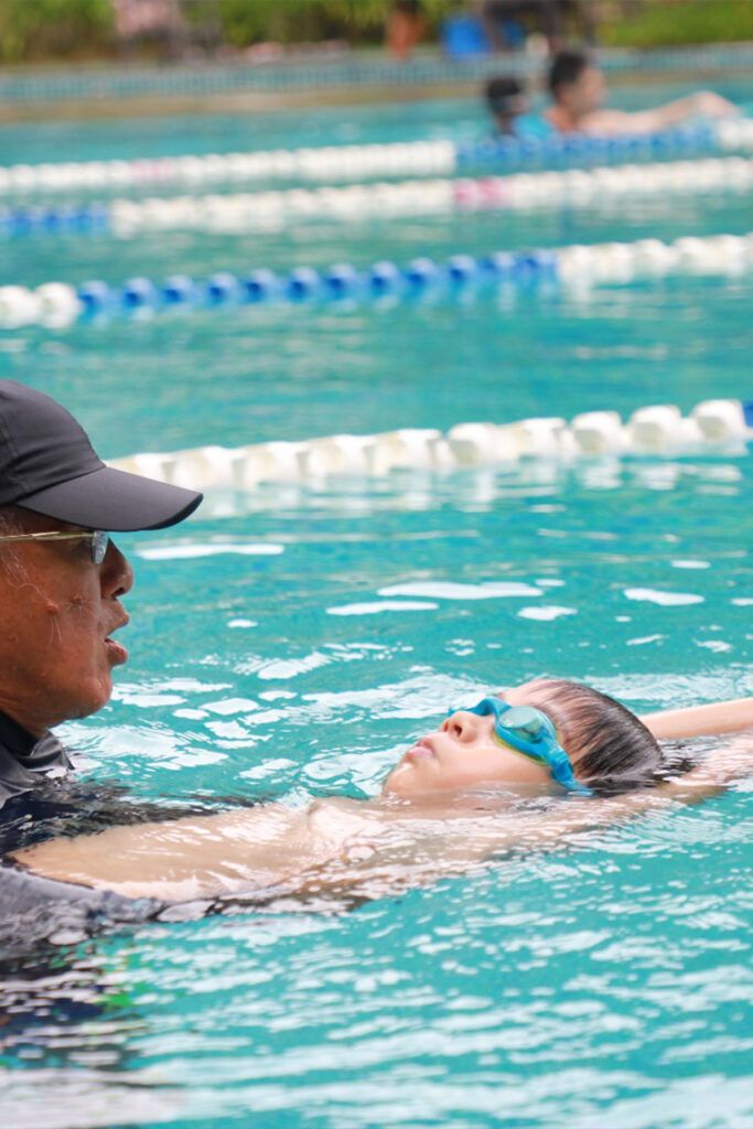 Coach working one to one with a swimmer