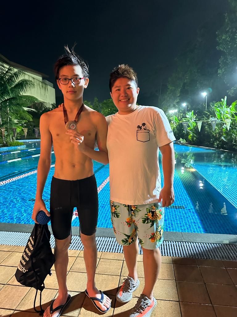 Coach with a young swimmer after training