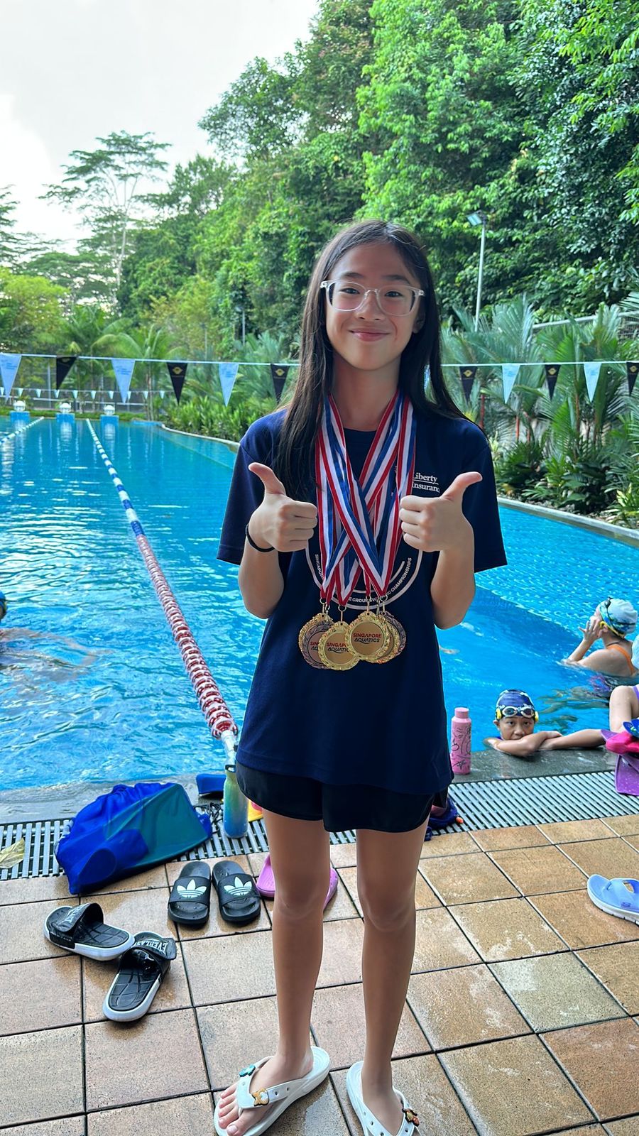 Young swimmer with her medals