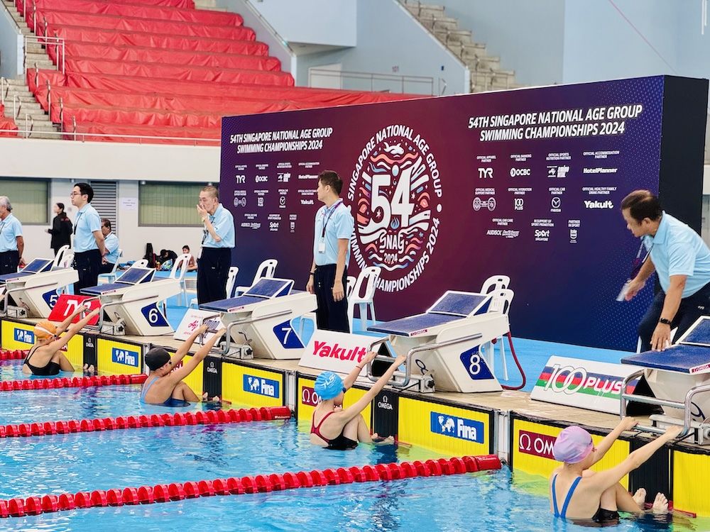 Swimmers on the blocks at a competition venue